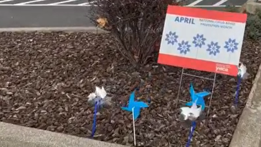 Photo: Sign with Child Abuse Prevention Month with blue pinwheels